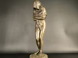 bronze statue of a woman holding a baby in her arms