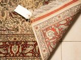 a rug on the floor with a piece of paper on it