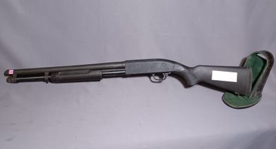 a shotgun that is sitting on top of a table