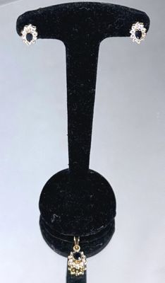 a close up of a pair of earrings on a display stand