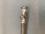 a metal pipe that has a statue on top of it