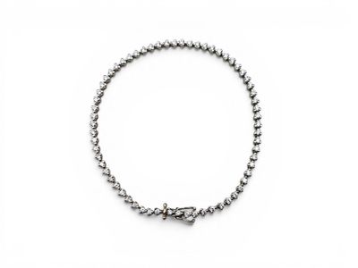a close up of a bracelet on a white surface
