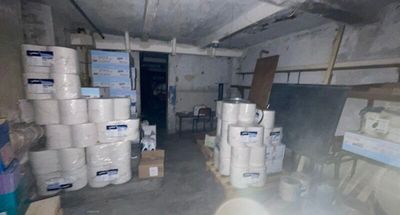 many rolls of toilet paper stacked on the floor