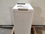 a white dishwasher sitting on a pallet in the middle of a room