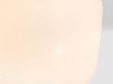 a close up of a ceiling light with a white shade on it