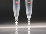 pair of clear wine glasses sitting on top of a table