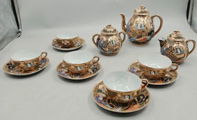 a group of tea pots and cups sitting on a table