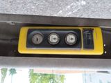 a yellow and black control panel on the side of a bus