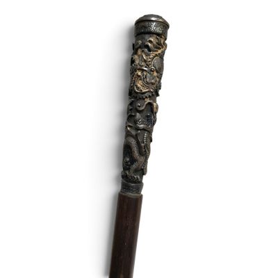 a close up of a wooden stick with a dragon on it