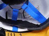 a close up of a helmet with a blue ribbon on it