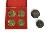 three coins are in a red box with a red lid
