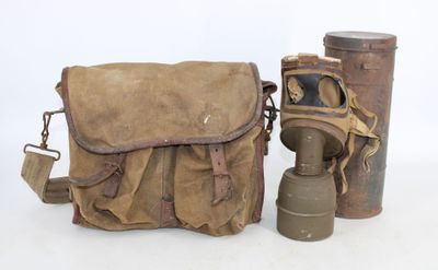 two old gas masks and a bag on a white background