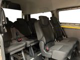 four seats in the back of a bus that are empty
