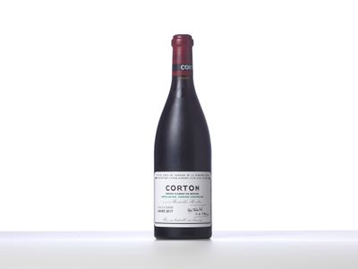 a bottle of red wine sitting on top of a table