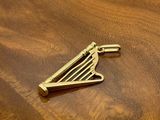 a gold pin sitting on top of a wooden table