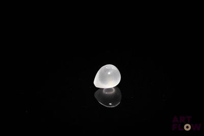 an image of a white heart shaped stone on a black surface