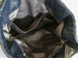 the inside of a blue leather purse with a zippered pocket