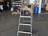 an image of a small industrial cleaning machine in a garage