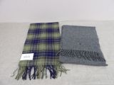 two scarves, one grey and one blue, are sitting on a table