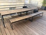 a wooden table and benches on a wooden deck