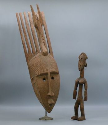 sculpture of a man and a woman standing next to each other with a fork in front of them