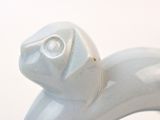 a white bird statue with a diamond on it ' s head
