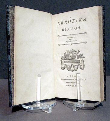 an open book on a table with a candle on it