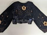 an image of a black jacket with sunflowers on it