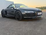 the black audi sports car is parked in a parking lot