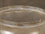 a close up of a glass jar with dirt on it