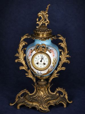an image of a blue and gold vase with a clock on it
