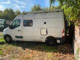 a white van that is parked next to a tree