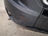 a close up of a car ' s front bumper with a sticker on it