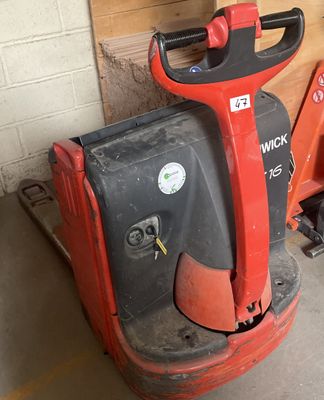 a red and black machine that is sitting in a garage
