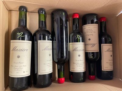 several bottles of wine in a cardboard box on a table