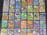 a large collection of pokemon cards are displayed on a table