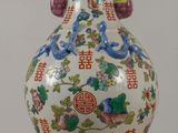a vase that is sitting on a table with asian characters on it