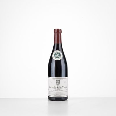 a bottle of red wine sitting on top of a white table