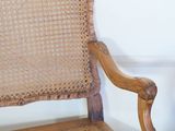 a wooden chair with a cane back and a cane seat