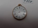 a gold pocket watch with roman numerals on it