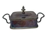 a silver plated casserole dish with handles and handles