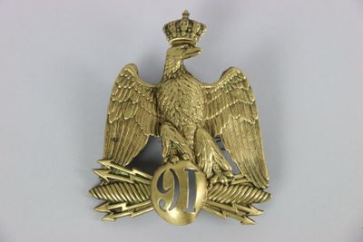 an image of a gold eagle with a crown on it ' s head