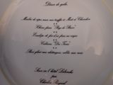 a plate with a poem written on it on a table