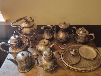 a table that has a lot of silver items on it