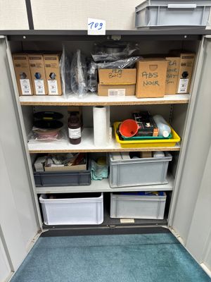 many boxes and containers on the shelves in the room