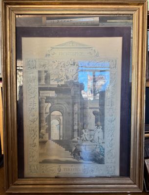 framed picture of a painting of a building in a room