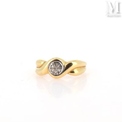 a close up of a gold ring with a diamond in the center