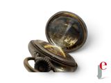 a close up of a pocket watch on a white surface