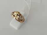 a close up of a gold ring on a white surface