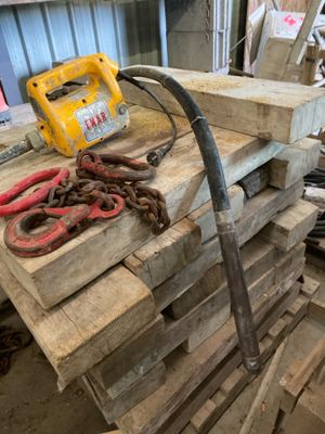 a pile of wood and a pair of scissors on a table